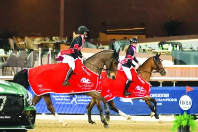 Sanne Thijssen astride Con Quidam RB and Sophie Hinners on Iron Dames Singclair celebrate after leading Cannes Stars to victory 
in the first leg of the Global Champions League at Al Shaqab on Friday.