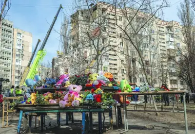 A makeshift memorial to the victims of a drone strike that heavily damaged an apartment building in Odesa is seen near the site.