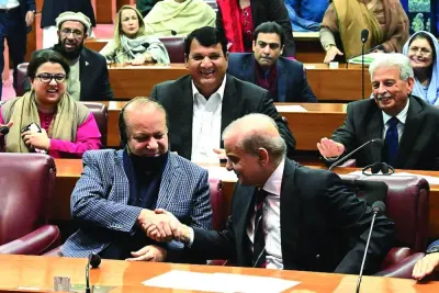 This handout photograph taken and released by the Pakistan National Assembly shows former prime minister Nawaz Sharif (left) greeting his younger brother and newly-elected Prime Minister Shehbaz at the Parliament House in Islamabad.