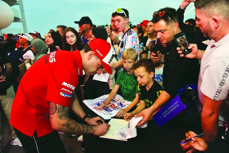 
Red Bull Tech3 rider Pedro Acosta signs autographs for fans. 