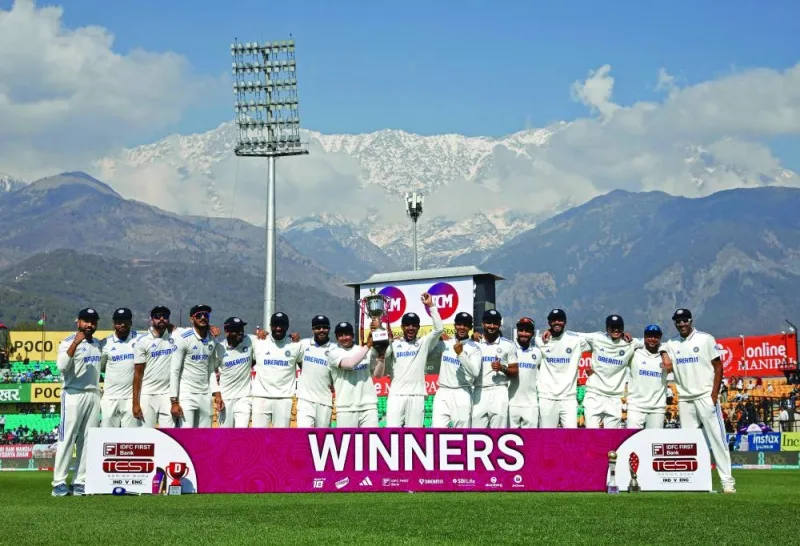 India’s players pose with the trophy after winning the fifth and last Test against England at the Himachal Pradesh Cricket Association Stadium in Dharamsala on Saturday. (AFP)