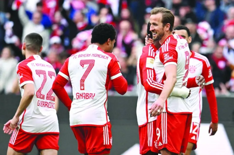 Bayern Munich’s Harry Kane (right) celebrates scoring his team’s seventh goal with teammates during the Bundesliga match against Mainz 05 in Munich on Saturday. (AFP)