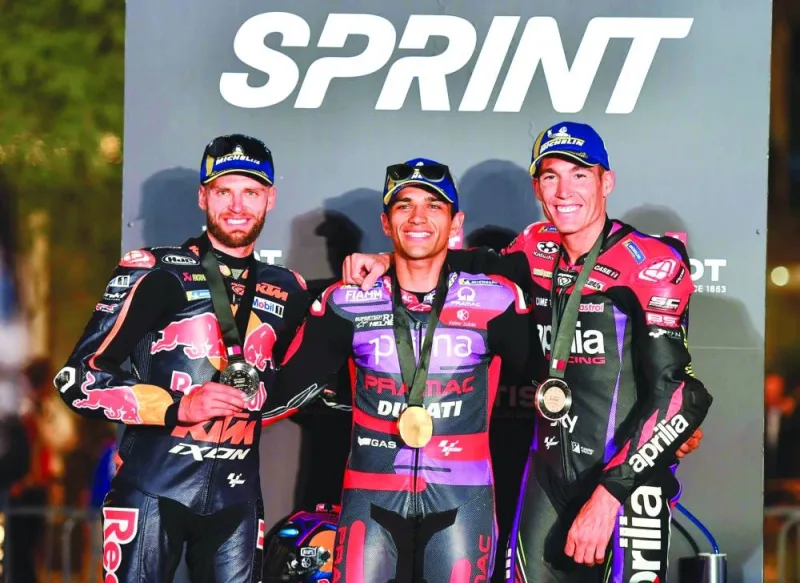 Jorge Martin (centre) celebrates on the podium after winning the sprint race alongside runner-up Red Bull KTM Factory Racing’s Brad Binder (left) and third-placed Aprilia Racing’s Aleix Espargaro on Saturday.
