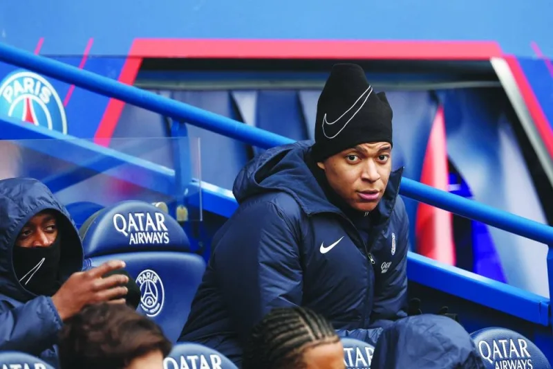 Paris Saint-Germain&#039;s French forward Kylian Mbappe sits on the bench before the start of the French L1 match against Stade de Reims at the Parc des Princes stadium in Paris yesterday. (AFP)