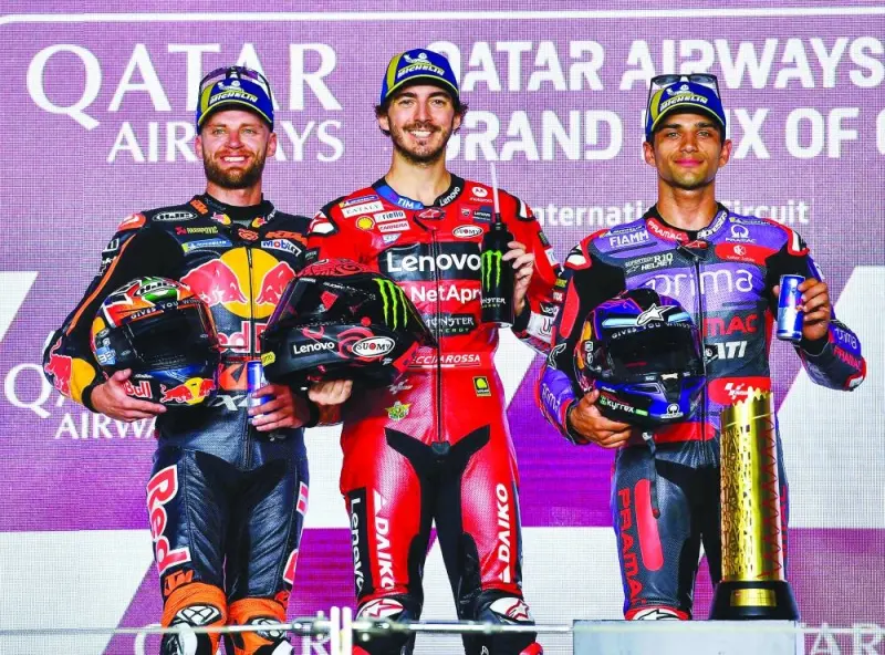 First placed Italian MotoGP rider Francesco Bagnaia of Ducati Lenovo Team, second placed South African MotoGP rider Brad Binder of Red Bull KTM Factory Racing and third placed Spanish MotoGP rider Jorge Martin of Prima Pramac Racing celebrate on the podium after the MotoGP race of the Motorcycling Grand Prix of Qatar at the Losail International Circuit in Doha yesterday. PICTURES: Noushad Thekkayil
