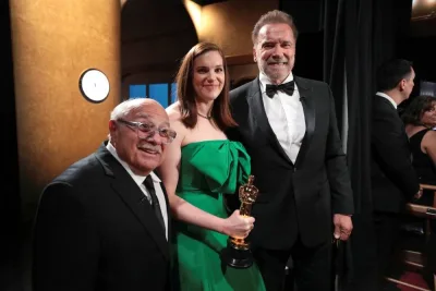Jennifer Lame poses with the Oscar for Best Film Editing for "Oppenheimer" along with Arnold Schwarzenegger and Danny DeVito backstage at the 96th Academy Awards in Los Angeles, California. Al Seib/A.M.P.A.S./Handout via REUTERS