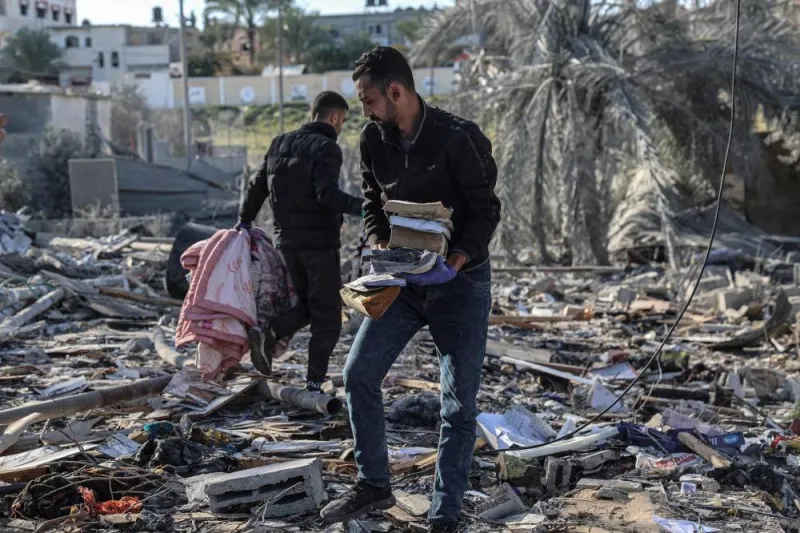 Palestinians search for their belongings amid the rubble of houses destroyed by Israeli bombardment in Rafah in the southern Gaza Strip on Monday. AFP