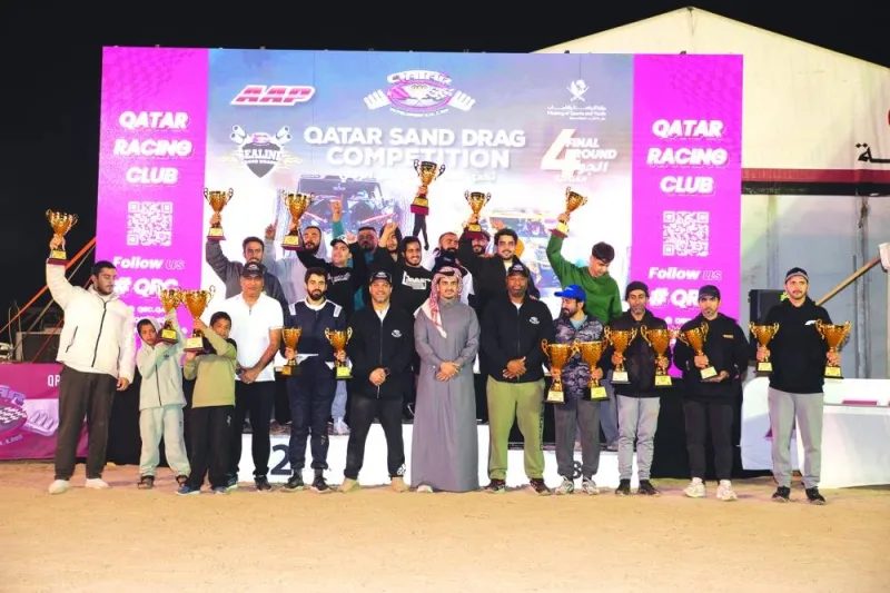 
Winners of the fourth and final round of the Desert Bike Race Competition pose with QRC Director Sheikh Jabor bin Khalid al-Thani. 