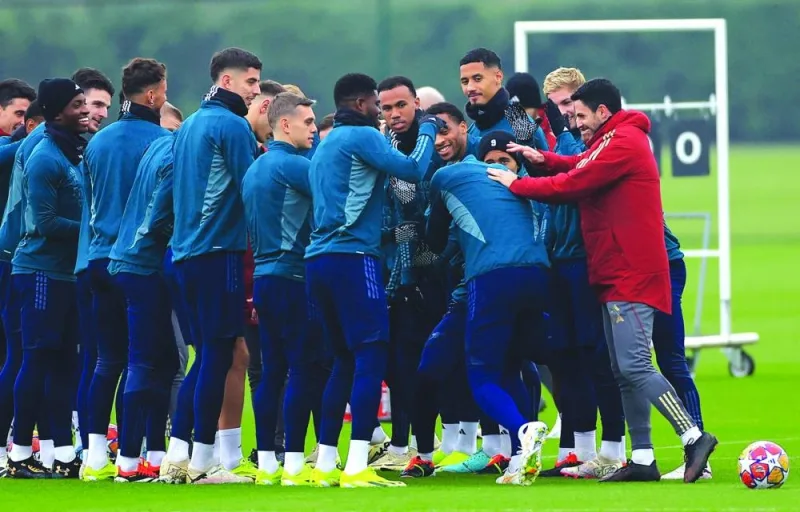 Arsenal manager Mikel Arteta (in red) is seen mingling with his players during a team training session at Arsenal Training Centre in London on Monday. (Reuters)