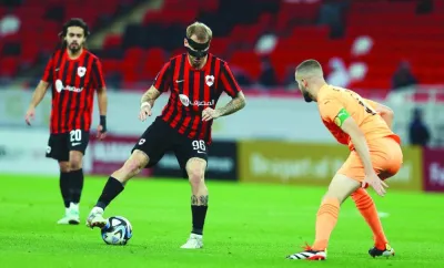 Al Rayyan’s Roger Guedes (left) vying for the ball with Umm Salal’s captain Victor Lekhal during their Expo Stars League match at the Ahmad Bin Ali Stadium on Tuesday.