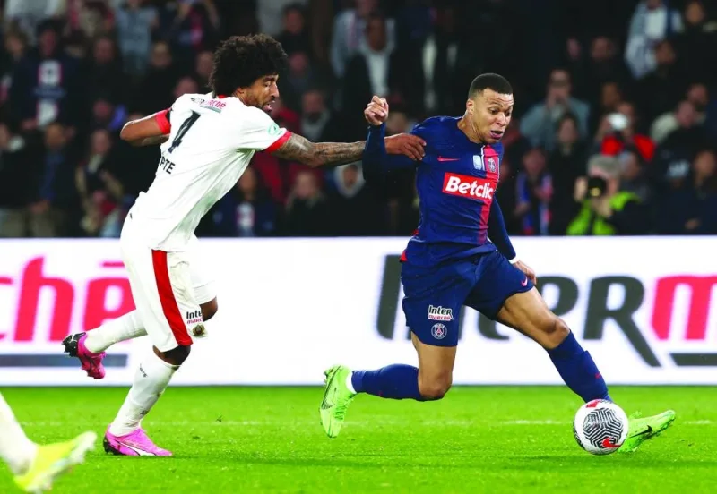 
Paris St Germain’s Kylian Mbappe (right) vies for the ball with Nice’s Dante during the French Cup quarter-final at the Parc des Princes in Paris on Wednesday. (Reuters) 
