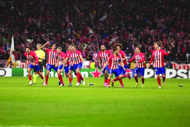 Atletico Madrid’s players celebrate after their win over Inter Milan on penalties in the Champions League last 16 second leg match at the 
Metropolitano stadium in Madrid on Wednesday. (AFP)