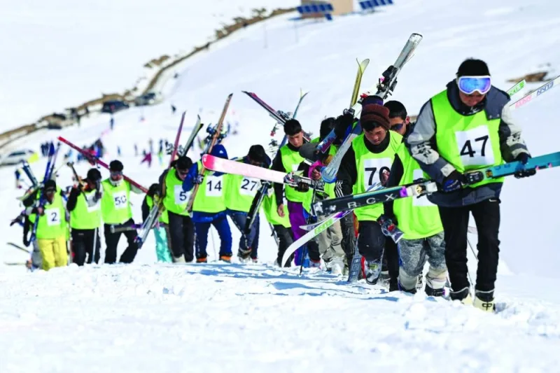 
Afghan skiers walk uphill to compete in a ski race on the outskirts of Bamiyan province last Friday. 