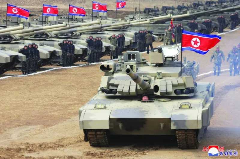 
North Korean leader Kim Jong-un sits inside a tank during a military demonstration involving tank units, in North Korea. 