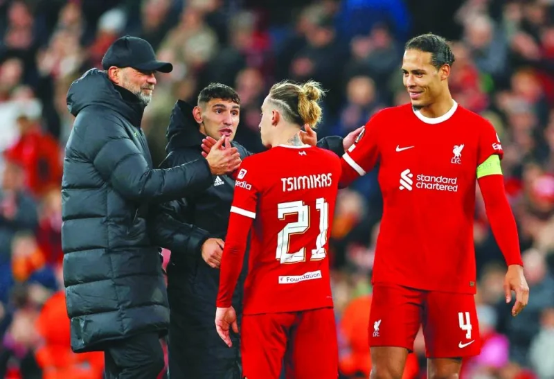 
Liverpool manager Jurgen Klopp (left) celebrates with his players Kostas Tsimikas and Virgil van Dijk after their win over Sparta Prague in the Europa League last 16 match. (Reuters) 
