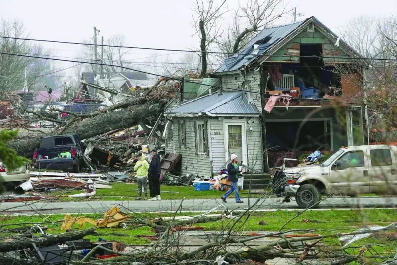 
People observe the damage after an overnight tornado tore through Lakeview, Ohio. 