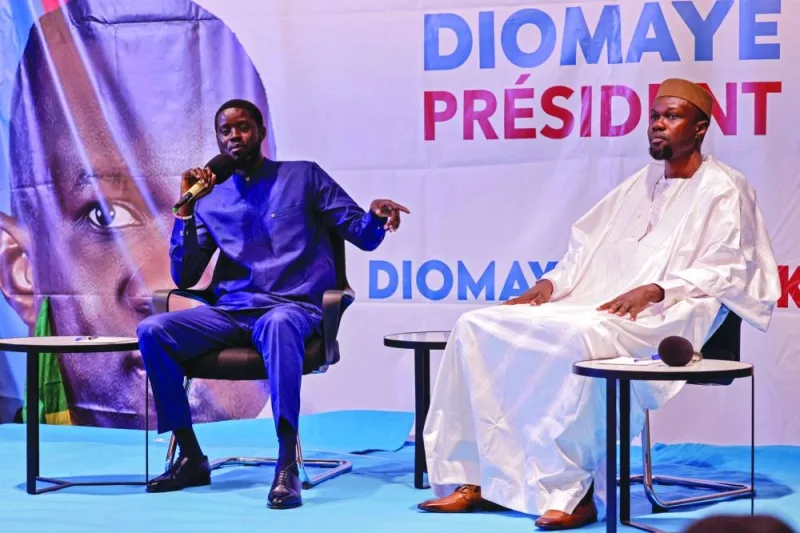 Senegalese opposition leader Ousmane Sonko (right) listens to the presidential candidate he is backing in the March 24 election, Bassirou Diomaye Faye, as they hold a joint press conference, in Dakar, on Friday.