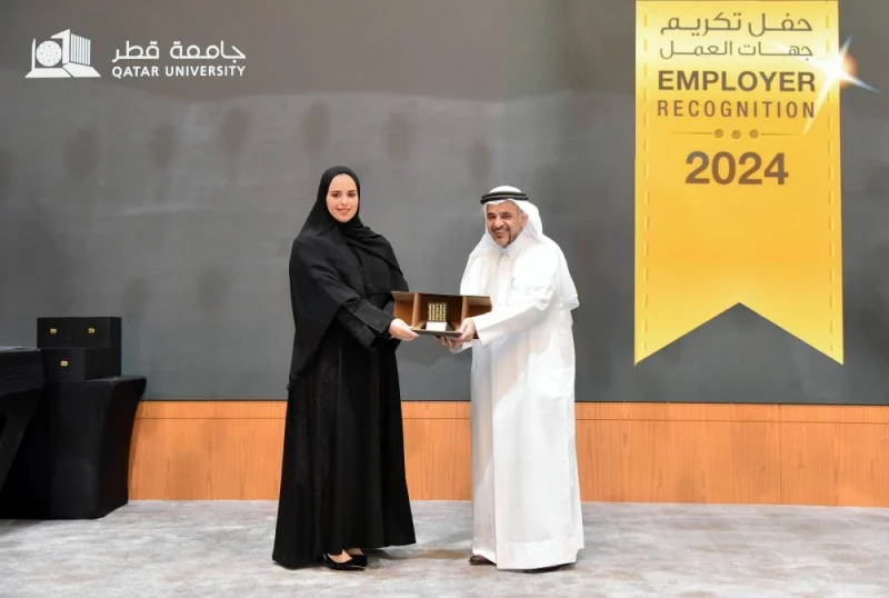 At a ceremony, Dr. Omar al-Ansari, president, Qatar University, presented the "distinguished shield of honour" to Samah Nasser al-Dhafiri, QIIB&#039;s director (Recruitment and Employee Affairs).