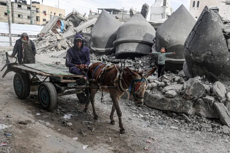 A man drives a donkey-pulled cart past the rubble of Al-Faruq Mosque, that was destroyed during Israeli bombardment, in Rafah on the southern Gaza Strip on Sunday. AFP