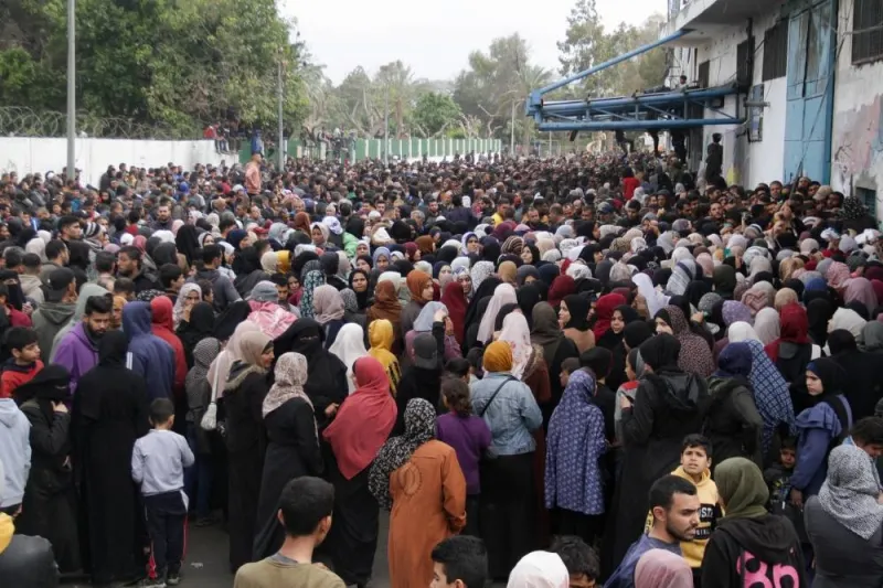 Palestinians gather to receive aid outside an UNRWA warehouse as Gaza residents face crisis levels of hunger, amid the ongoing conflict between Israel and Hamas, in Gaza City, on Monday. REUTERS