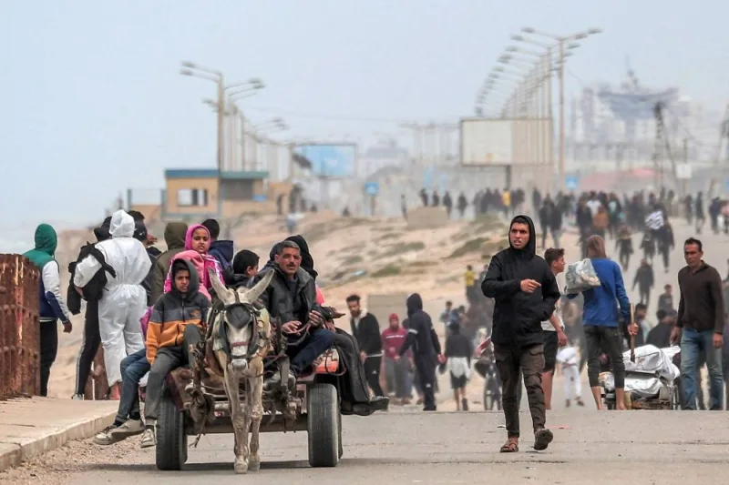 Displaced Palestinians fleeing from the area in the vicinity of Gaza City&#039;s al-Shifa hospital arrive via the coastal highway at the Nuseirat refugee camp in the central Gaza Strip on Monday. AFP