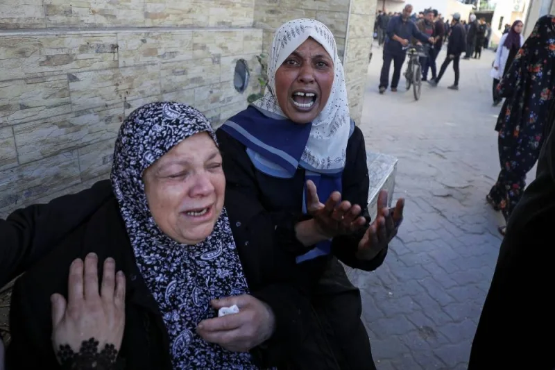 Women react during the funeral of Palestinian men from an array of clans and factions, who secure aid convoys in Gaza, after they were killed in an Israeli strike, in Gaza City, Wednesday. REUTERS