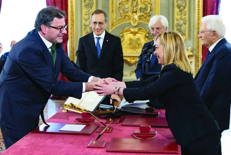 
Italy’s new Economy Minister Giancarlo Giorgetti shakes hands with Prime Minister Giorgia Meloni during the swearing-in ceremony at the Quirinale Presidential Palace in Rome on October 22, 2022. (Reuters/file photo) 