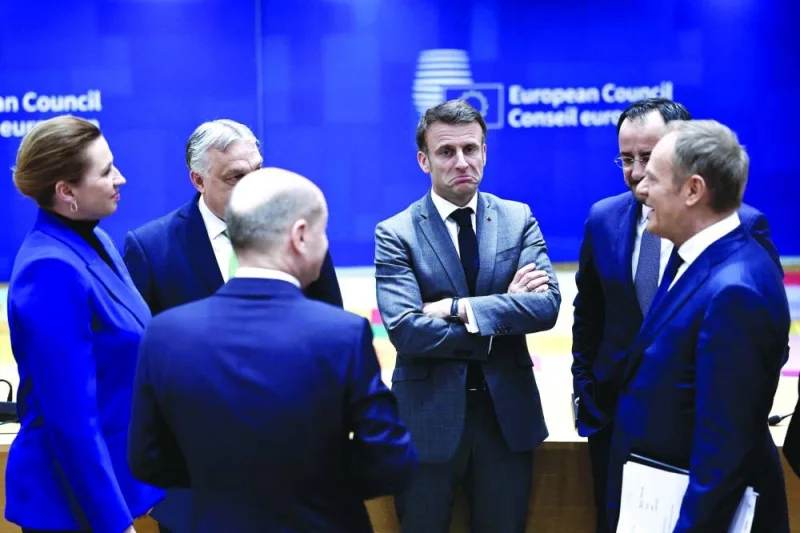 French President Emmanuel Macron (centre) reacts as he speaks with fellow EU leaders before a European Council summit at the EU headquarters in Brussels on Thursday. (AFP)