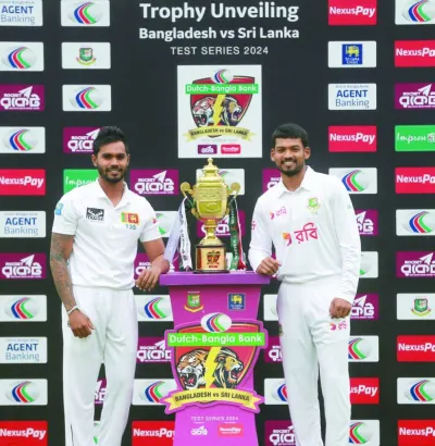 Bangladesh skipper Najmul Hossain Shanto (right) and his Sri Lankan counterpart Dhananjaya de Silva pose with the trophy in Sylhet on Thursday. (@BCBtigers)