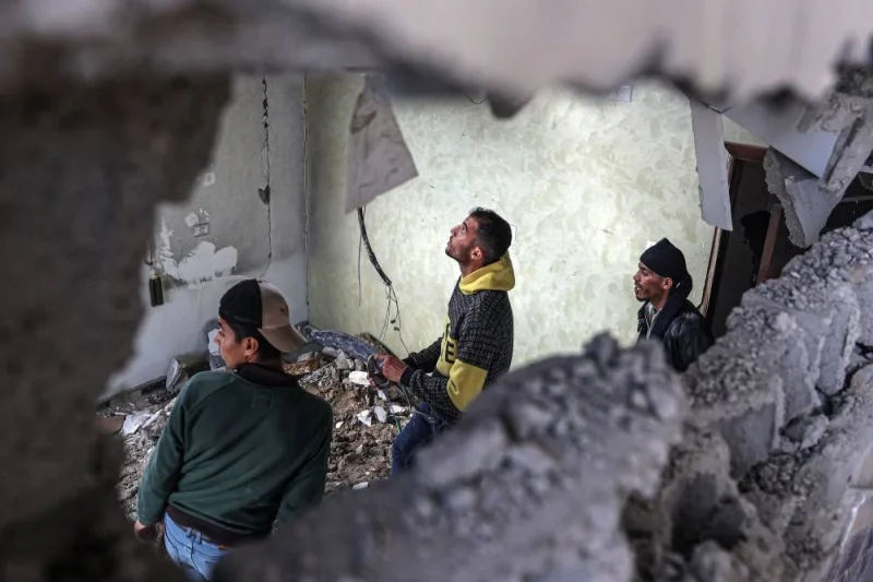 Palestinians check the damage inside a flat hit by Israeli bombardment in the Rafah in the southern Gaza Strip on Friday. AFP