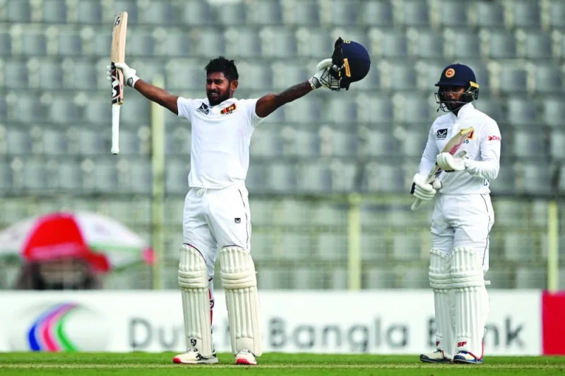 
Sri Lanka’s Kamindu Mendis (left) celebrates next to teammate Dhananjaya de Silva after scoring a century during the first day of the first Test against Bangladesh at the Sylhet International Cricket Stadium. (AFP) 