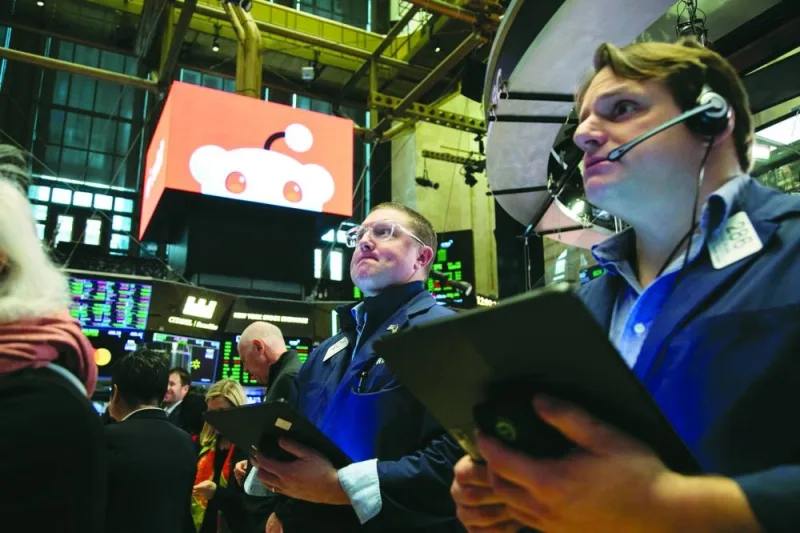 
Traders work during the Reddit initial public offering on the floor of the New York Stock Exchange on Thursday. Reddit’s first-day jump fattened the wallets of the social media platform’s users who were given the unusual opportunity to buy shares at the initial public offering price as well as longtime investors benefiting from the rebound in the company’s valuation. 
