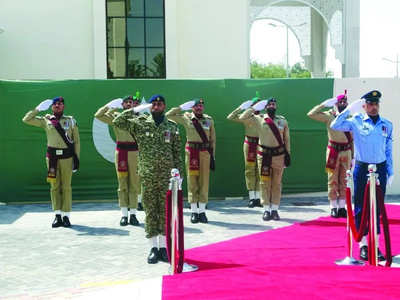 The military contingent saluting the national flag.