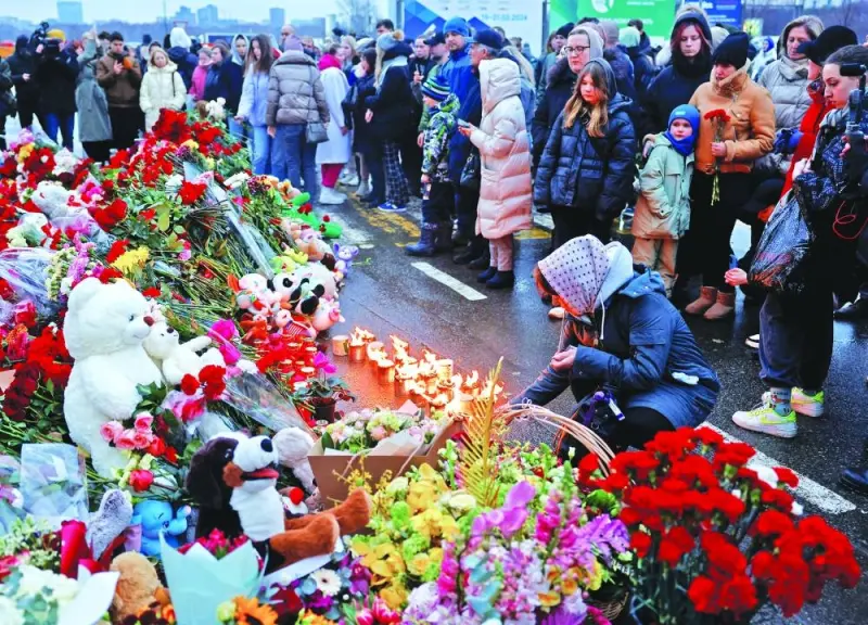 People gather at a makeshift memorial to the victims of a shooting attack set up outside the Crocus City Hall concert venue in the Moscow Region, Saturday. People gather at a makeshift memorial to the victims of a shooting attack set up outside the Crocus City Hall concert venue in the Moscow Region, Saturday.