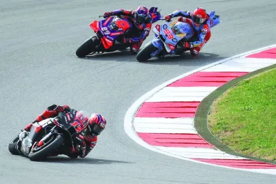 
Maverick Vinales (left) rides ahead of Jorge Martin (centre) and Marc Marquez during the sprint race at the Portuguese Grand  in Portimao. (AFP) 