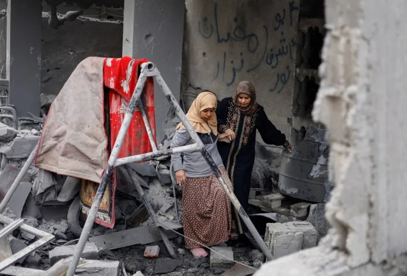 Palestinians inspect the site of an Israeli strike on a house in the southern Gaza Strip, on Sunday. REUTERS