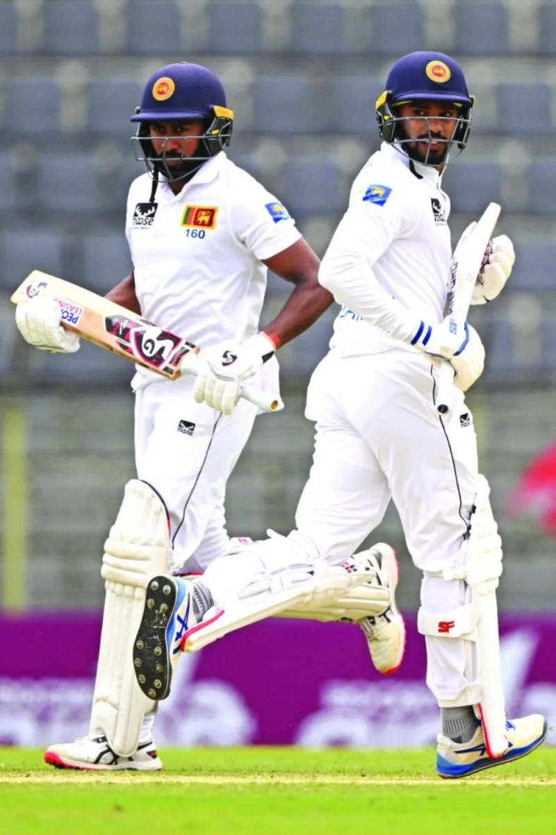 Sri Lanka’s Dhananjaya de Silva (right) and Kamindu Mendis run between the wickets during the third day of the first Test against Bangladesh at the Sylhet International Cricket Stadium in Sylhet yesterday. (AFP)