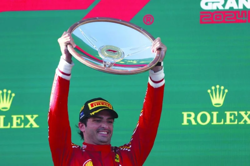 
Ferrari’s Spanish driver Carlos Sainz Jr celebrates with the trophy on the podium after winning the Australian Formula One Grand Prix at Albert Park Circuit in Melbourne yesterday. (AFP) 