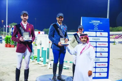 
Faisal al-Kahla, Deputy Director of the Longines Hathab Championship, awards the Big Tour winners of Longines Hathab Round 10, Season 7, at the Qatar Equestrian Federation’s outdoor arena on Saturday. 