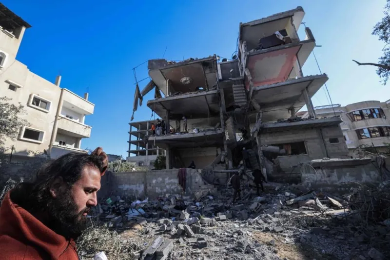 A man inspect the damage to a building after overnight Israeli bombardment in Rafah in the southern Gaza Strip on Monday. AFP