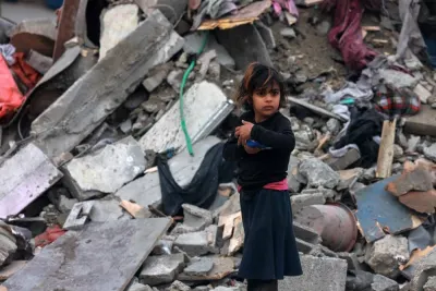 A young Palestinian girl stands amid the rubble of a building hit by overnight Israeli bombardment in Rafah in the southern Gaza Strip on Sunday. AFP