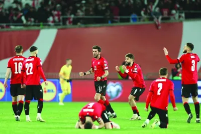 Georgia’s players react after their penalty shootout win over Greece in the UEFA Euro 2024 qualifying play-off in Tbilisi on Wednesday. (AFP)