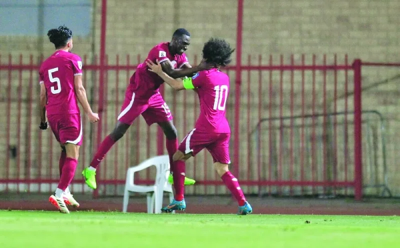 Qatar’s Almoez Ali (centre) celebrates with Akram Afif after scoring against Kuwait during the World Cup 2026 and Asian Cup 2027 qualification match at Sabah Al Salem Stadium in Kuwait City on Wednesday.