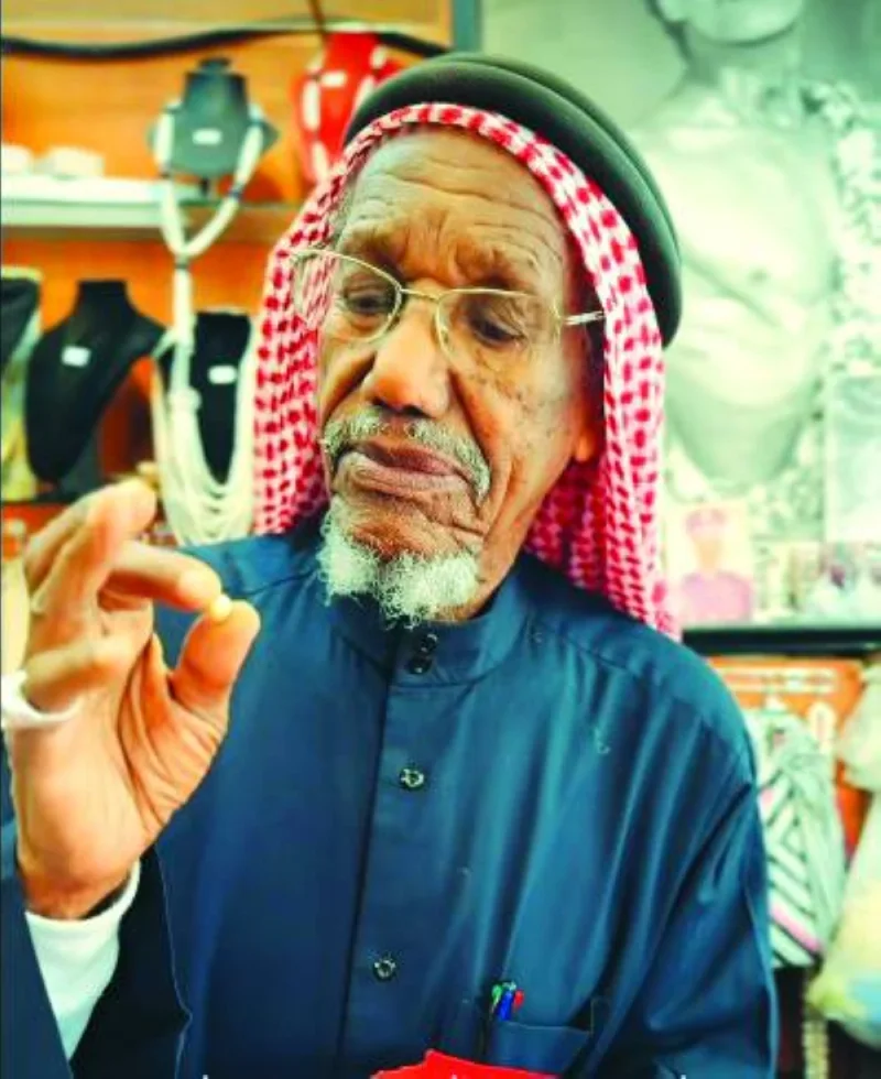 Saad Ismael Khalifa al-Jassim showcases some of the pearls at his shop at Souq Waqif. -screengrab from Visit Qatar&#039;s FB page