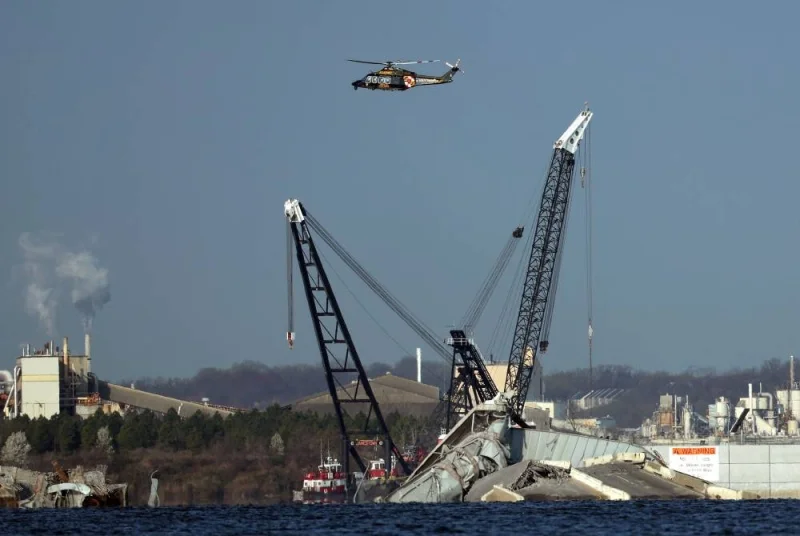 A crane works on the debris of the Francis Scott Key Bridge on Friday in Baltimore, Maryland. AFP