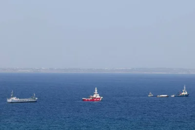The Open Arms, a rescue vessel owned by a Spanish NGO, a cargo ship and a tug boat depart with humanitarian aid for Gaza from Larnaca, Cyprus, on Saturday. REUTERS