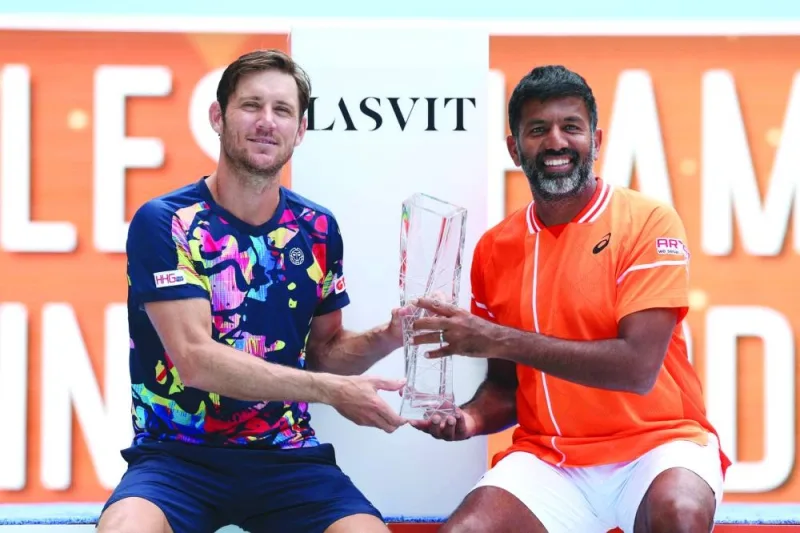 Matthew Ebden of Australia and Rohan Bopanna of India hold the trophy after winning the doubles final in Miami on Saturday. (AFP)