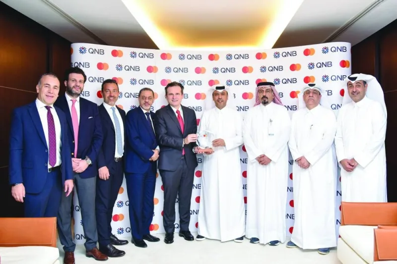 Abdulla Mubarak al-Khalifa, Chief Executive Officer, QNB Group receiving the ‘Fastest growing commercial credit cards portfolio in Qatar’ from Mastercard&#039;s president, Eastern Europe, Middle East and Africa (EEMEA) Dimitrios Dosis. Senior executives from QNB Group and Mastercard are also seen.