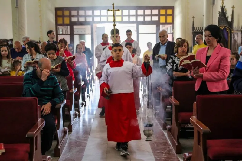 Palestinian Christians celebrate Easter Sunday Mass at the Catholic Holy Family Church in Gaza City, on Sunday. AFP
