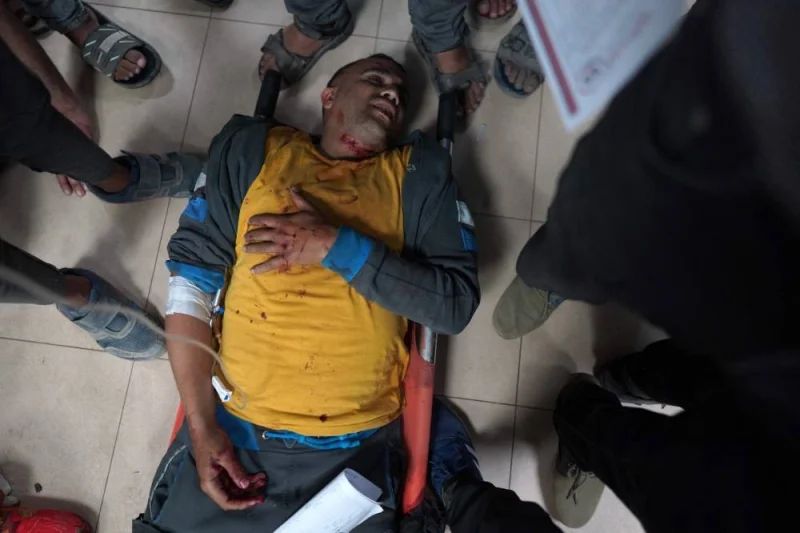 An injured Palestinian man lies on a stretcher in a corridor at the Al-Aqsa Martyrs Hospital in Deir al-Balah in the central Gaza Strip, following Israel bombardment on Sunday. AFP